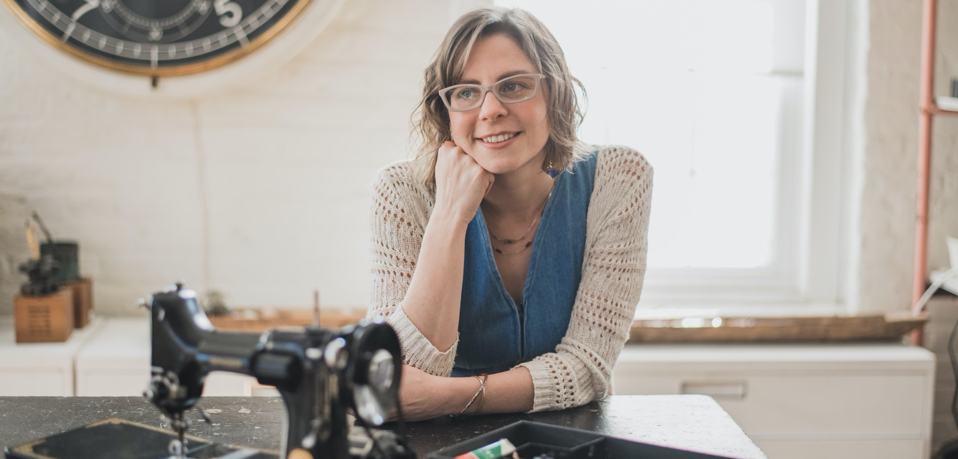 Lisa sitting behind sewing machine