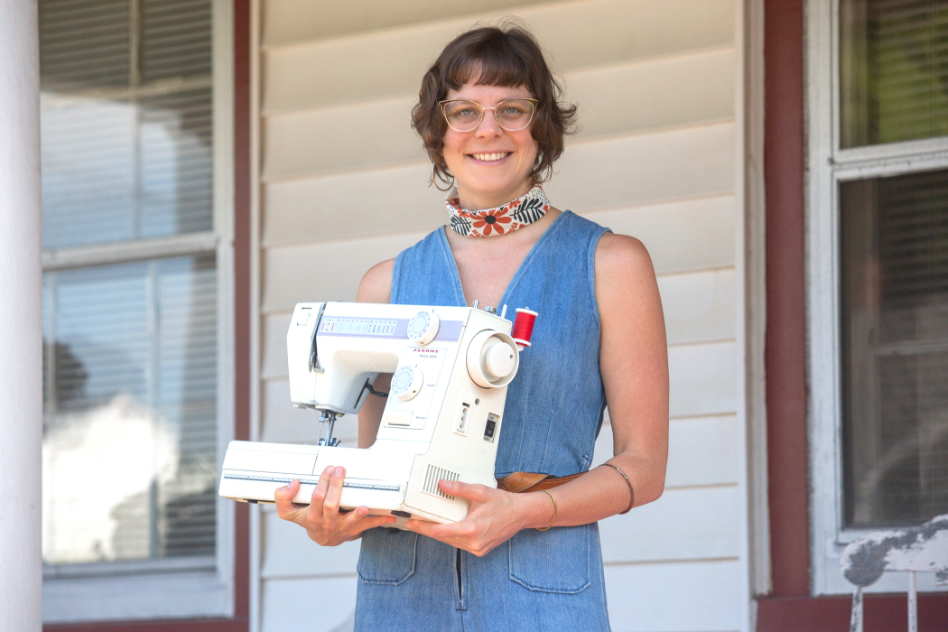 Lisa holding sewing machine on porch